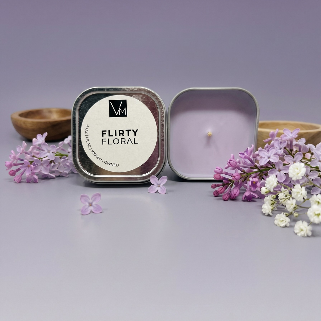 Flirty Floral candle in a tin with flowers on a gray background
